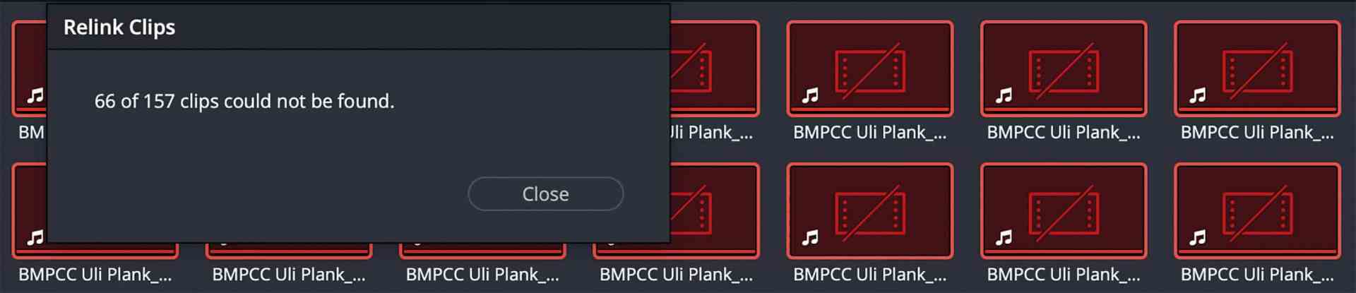 a software interface displaying a message stating that 66 out of 157 clips could not be found with several red thumbnail images visible in the background the message box is prominent in the center digital production A software interface displaying a message stating that 66 out of 157 clips could not be found, with several red thumbnail images visible in the background. The message box is prominent in the center.