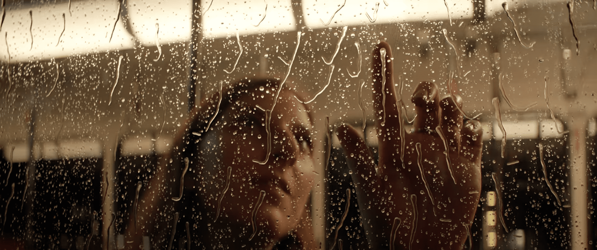 a woman with long hair presses her finger against a raincovered window her face appearing contemplative as droplets trickle down the glass the background shows hints of warm indoor lighting digital production A woman with long hair presses her finger against a rain-covered window, her face appearing contemplative as droplets trickle down the glass. The background shows hints of warm indoor lighting.