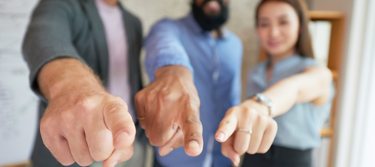 3-coach-executives-pointing-their-fingers